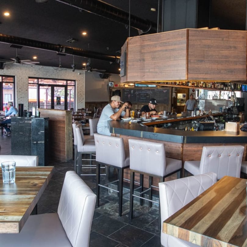 Alejandra's Mexican Restaurant interior with customers seated at the bar and dining tables.