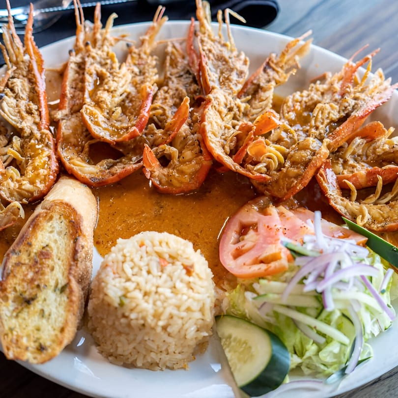 Alejandra's Mexican Restaurant's plate of grilled shrimp in sauce, rice, garlic bread, and salad.
